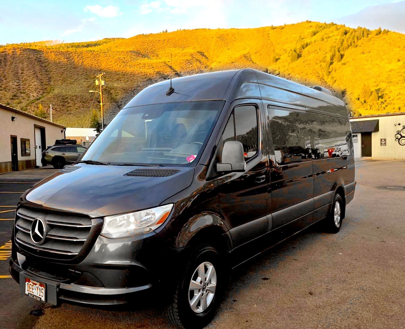 A 15 passenger van in black front view