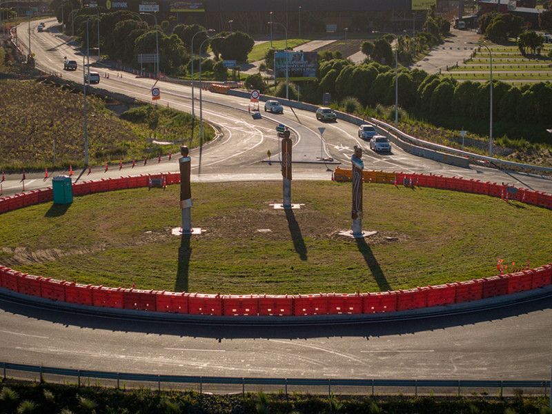 An aerial view of a roundabout with cars driving around it