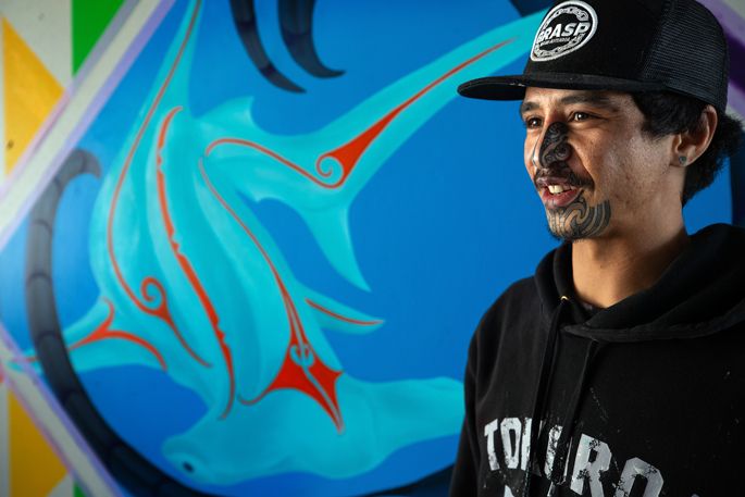 A man wearing a hat and a hoodie with the word toro on it