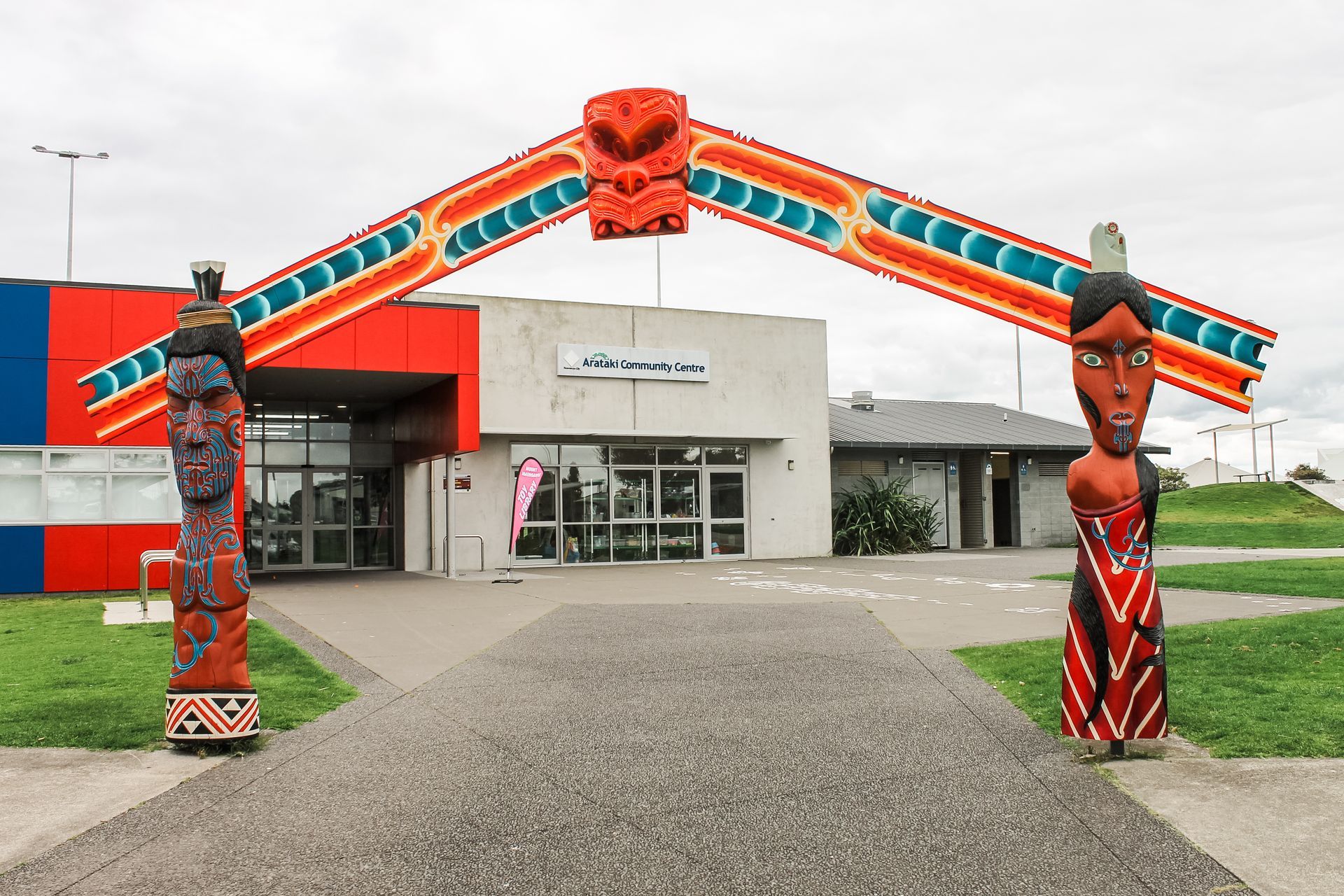 A building with a totem pole in front of it