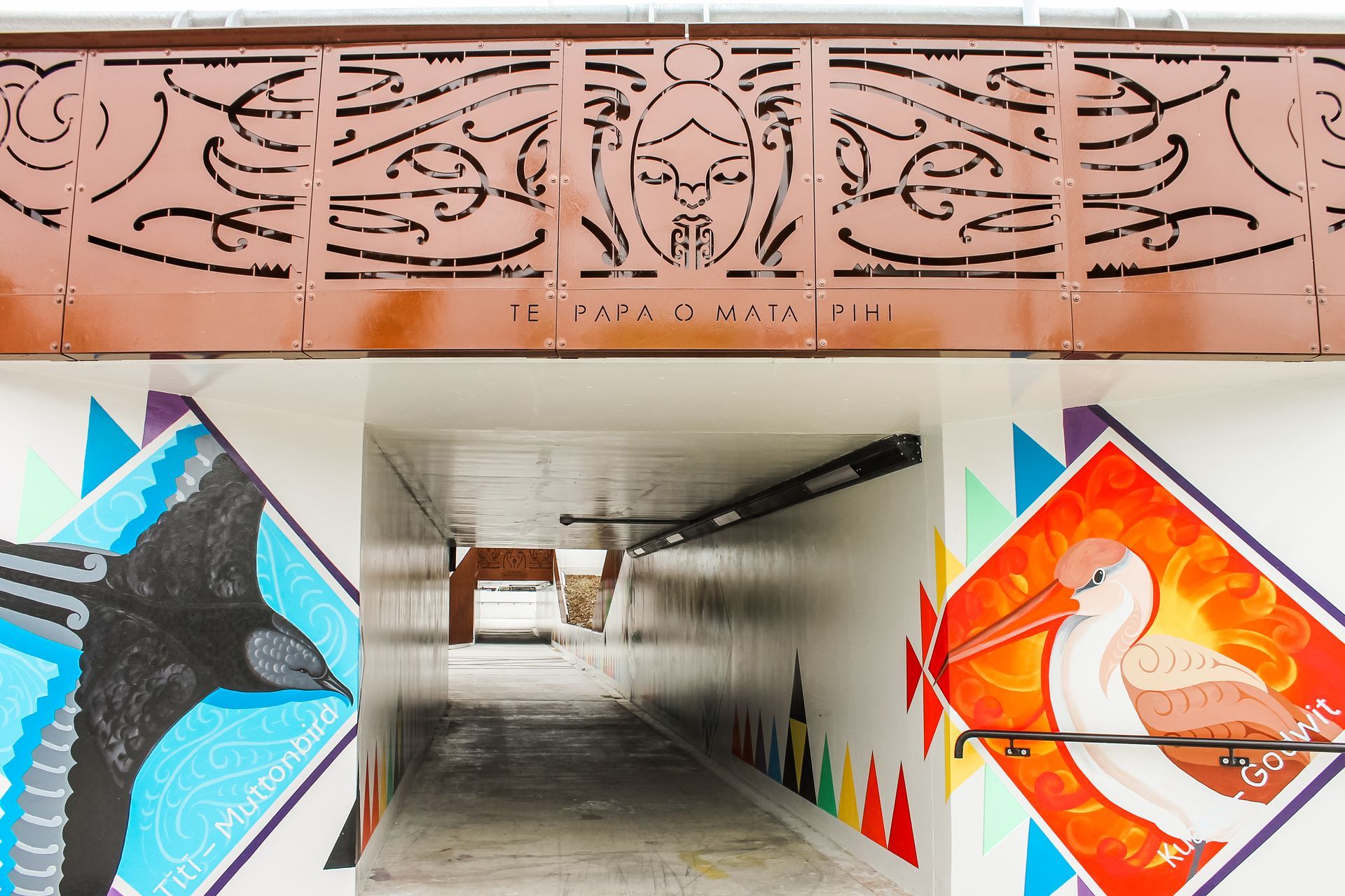 A tunnel with a painting of a pelican on the wall