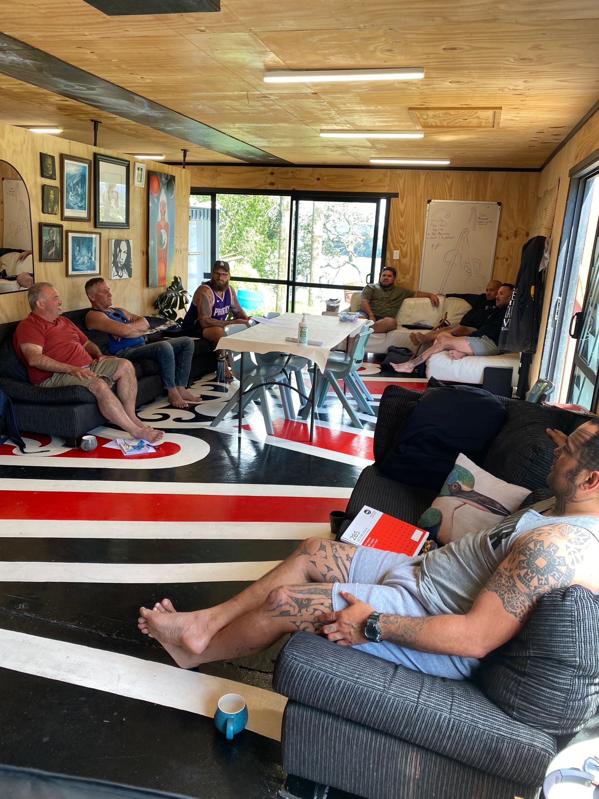 A group of men are sitting in a living room.