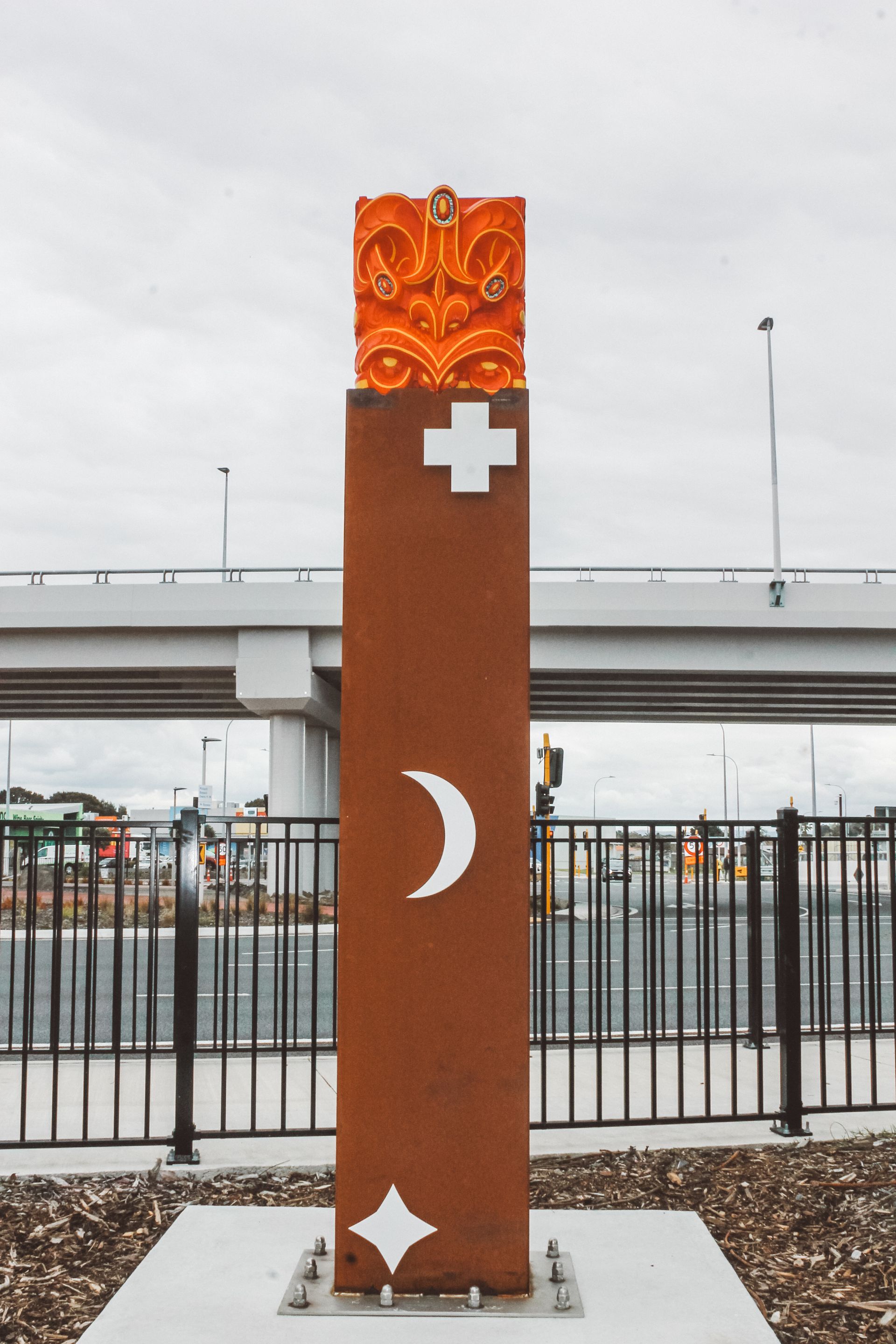 A statue with a cross and a crescent moon on it