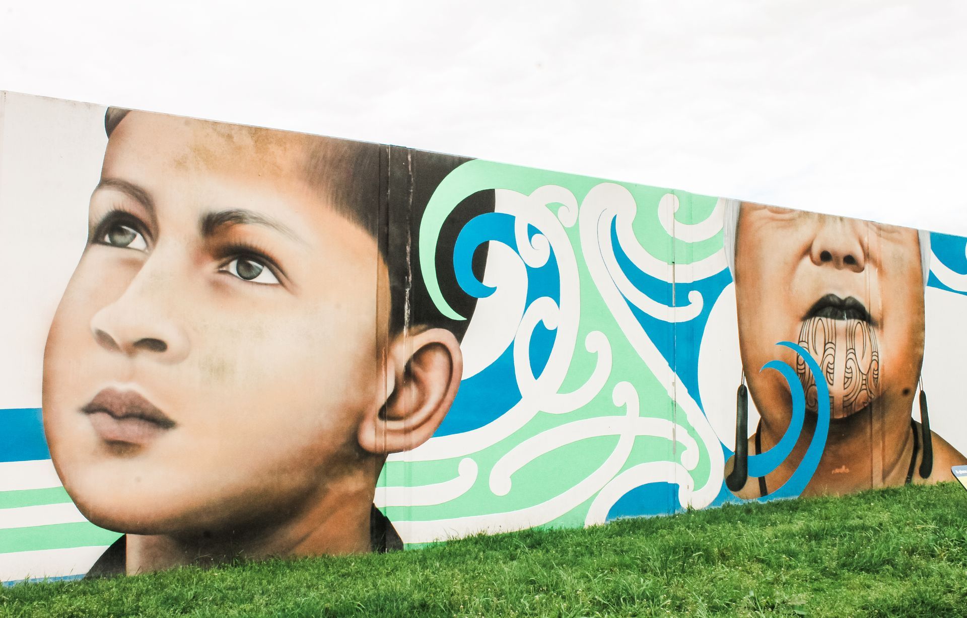 A mural of a boy and a woman on a wall.