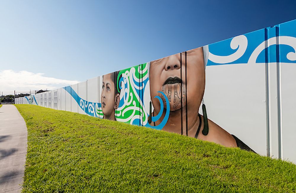 A fence with a painting of a woman 's face on it