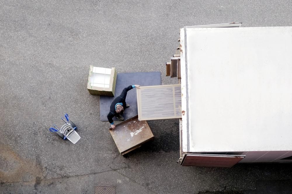 An Aerial View of a Man Loading Boxes Into a Truck — Express City Couriers In Edge Hill, QLD