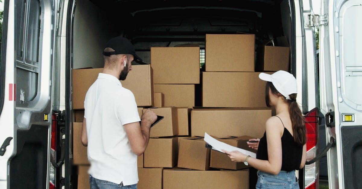 A Man and a Woman Are Standing in Front of a Van Filled With Boxes — Express City Couriers in Palm Cove, QLD