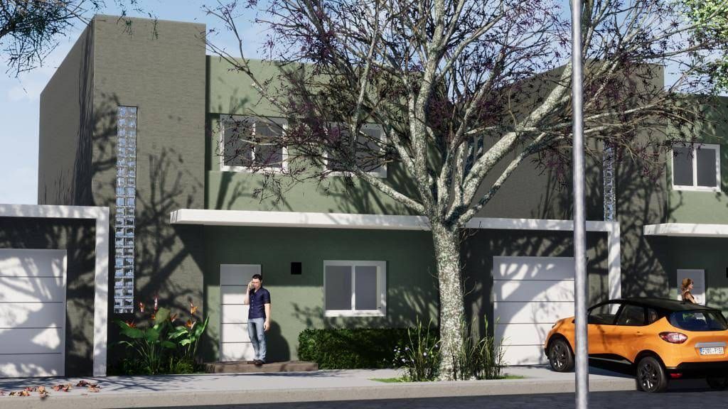 Hilera de casas adosadas modernas y verdes con una persona parada en una puerta y un auto estacionado en frente.