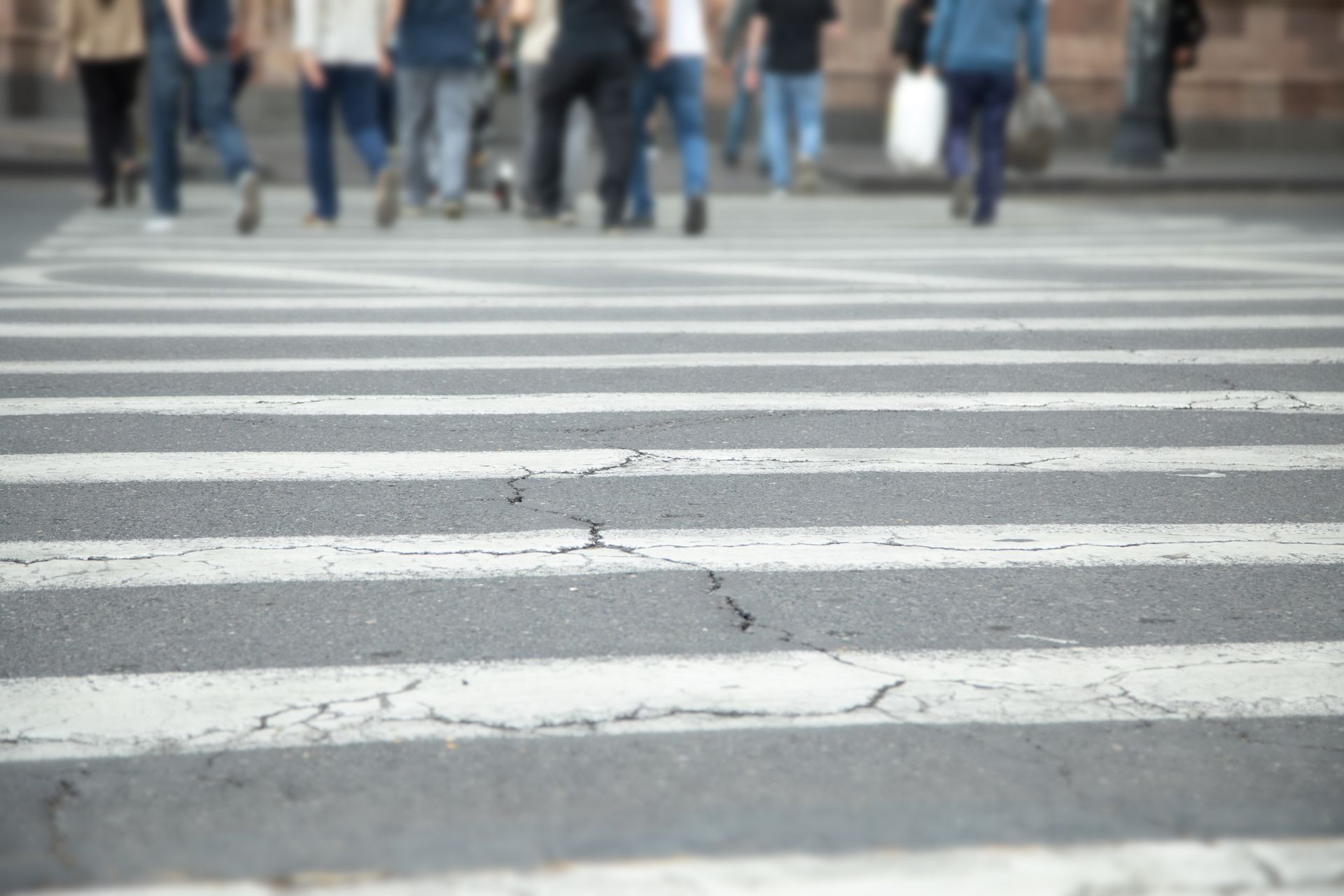 A group of people are walking across a crosswalk.