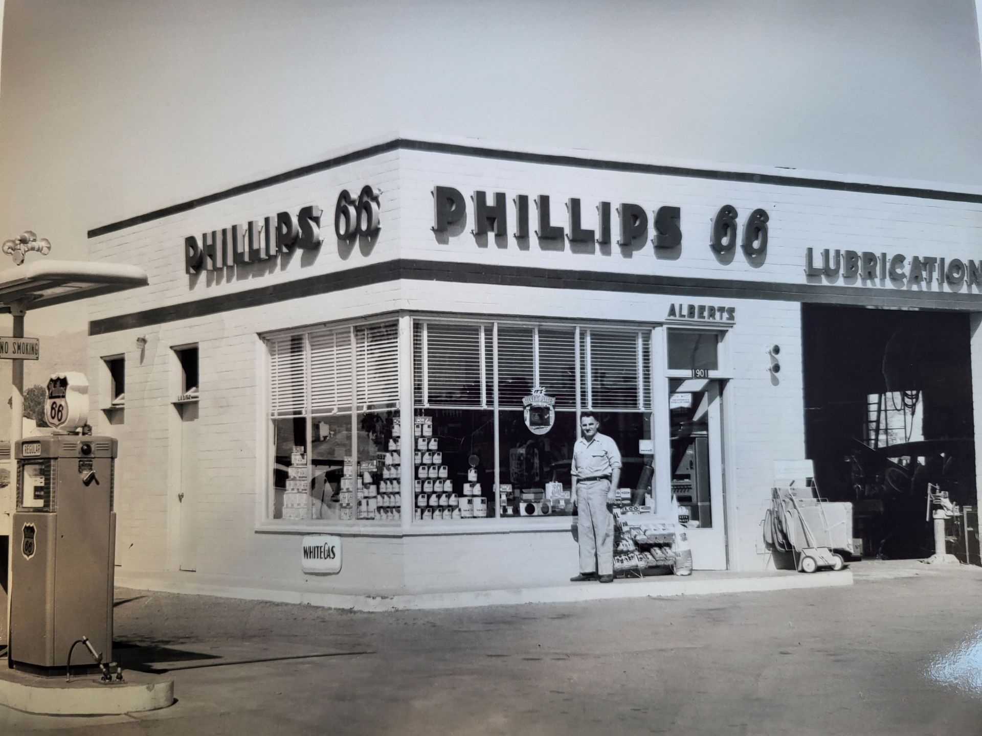 A picture of a phillips 66 auto mechincs shop in black anc white