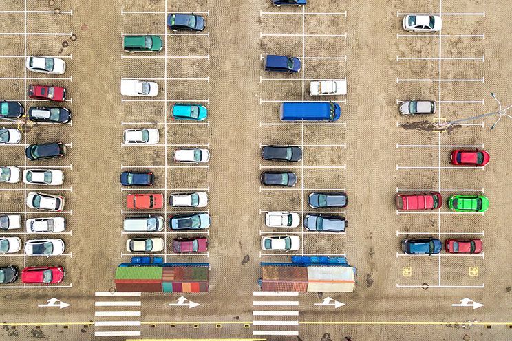 an aerial view of a parking lot filled with cars and trucks .