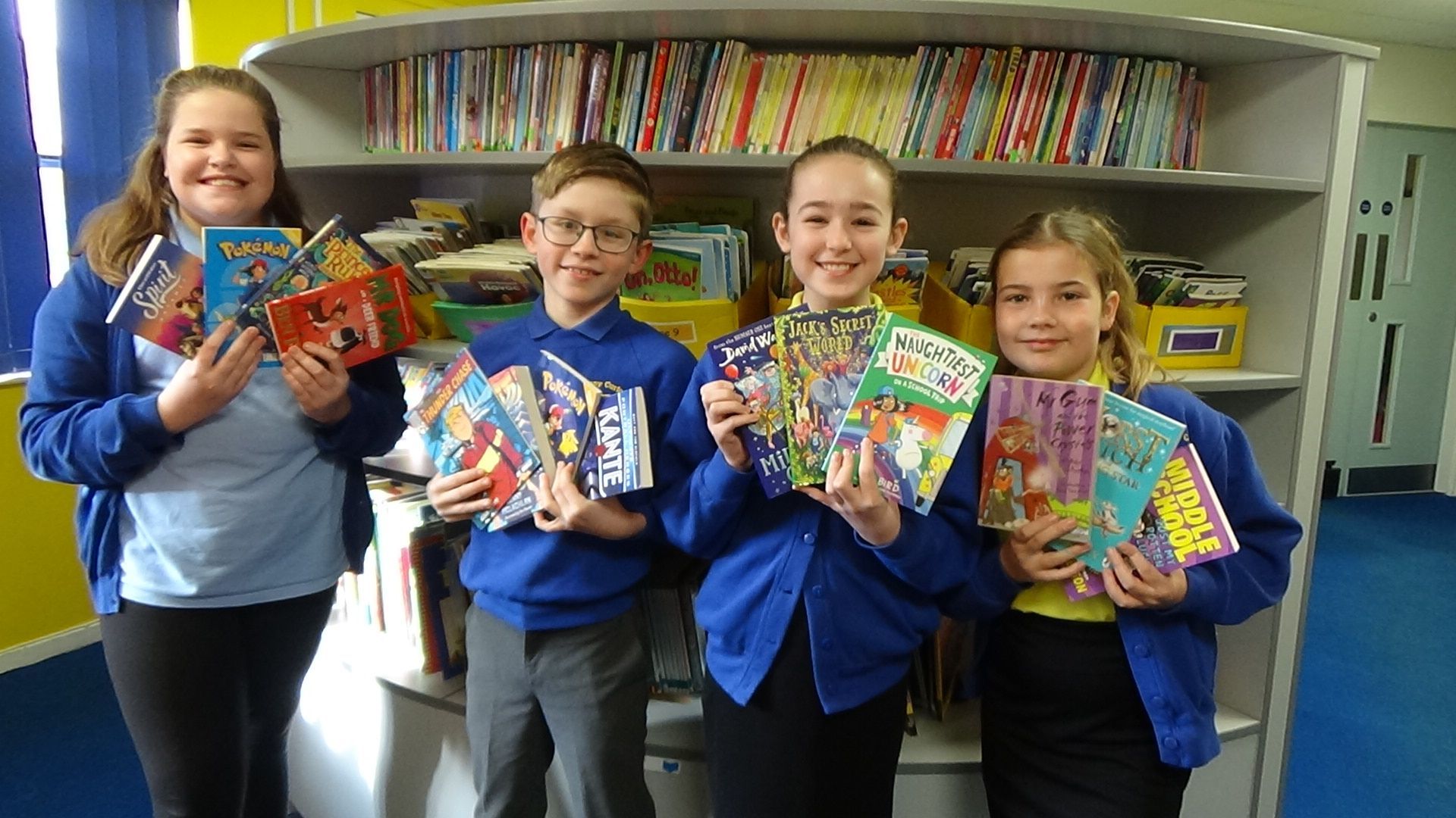 Anthony Curton pupils holding their new books