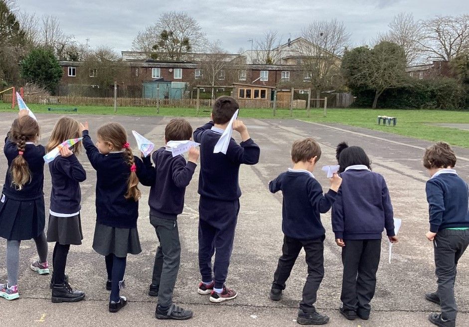 St Luke's pupils throwing paper aeroplanes