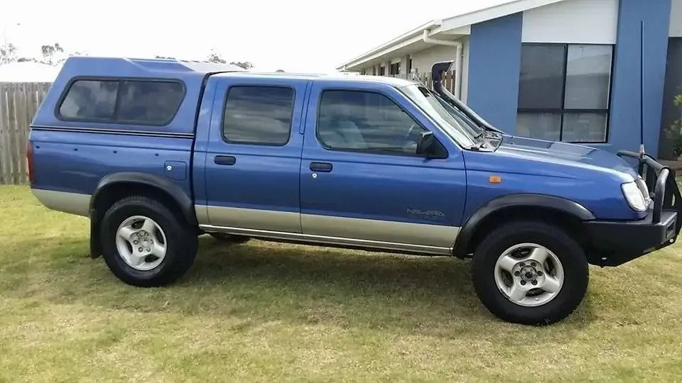 A Blue Truck With A Canopy Is Parked In Front Of A House — CQ Auto Tint In Kawana, QLD