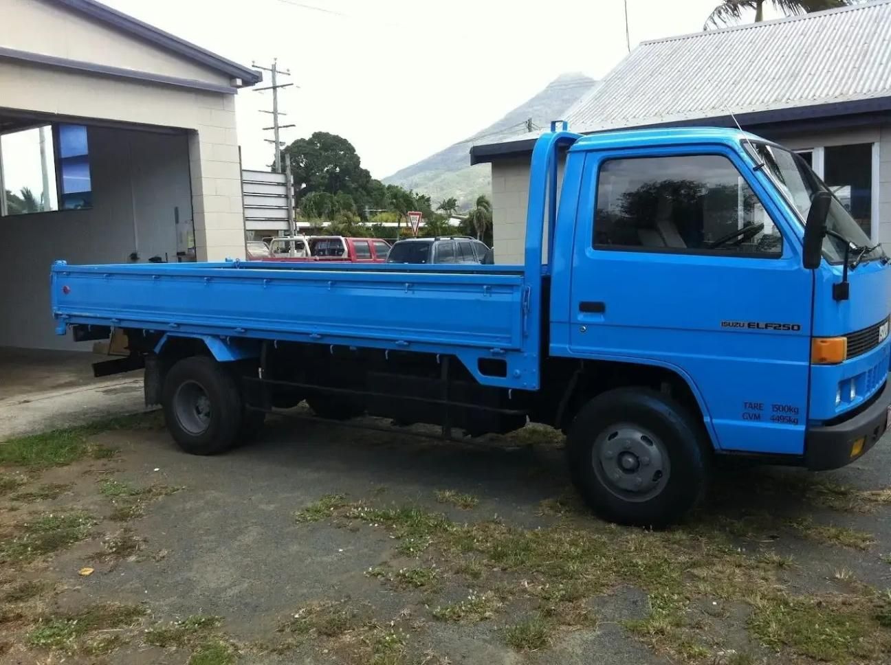 A Blue Truck Is Parked In Front Of A Garage — CQ Auto Tint In Kawana, QLD