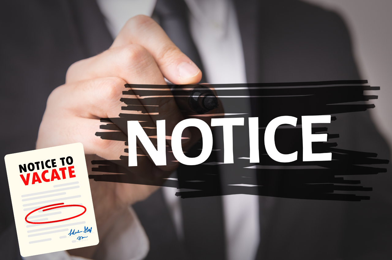 Someone writing notice and a notice to vacate in the corner of the image
