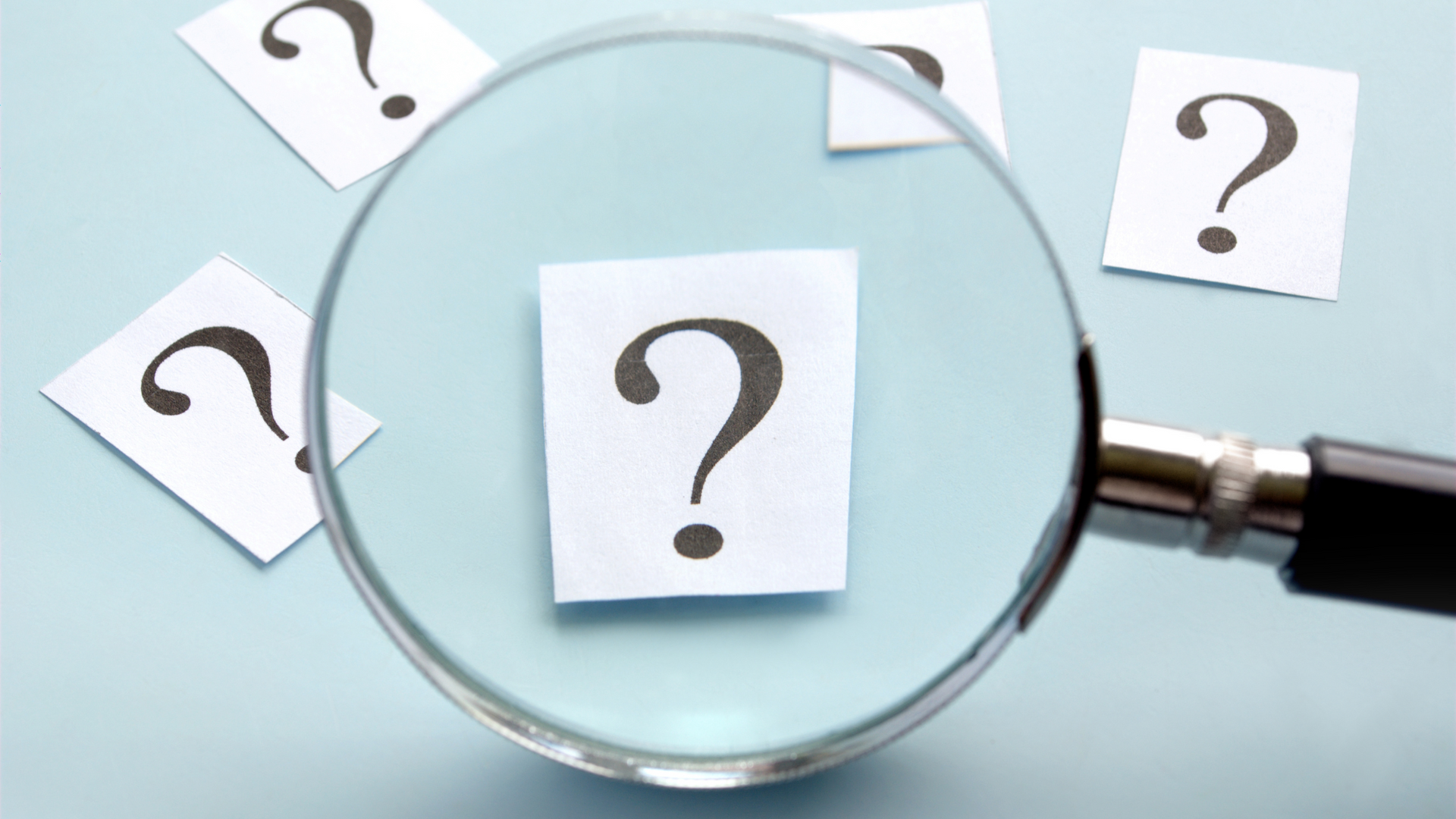 Magnifying glass over a question mark illustrating legal questions or tenant rights confusion