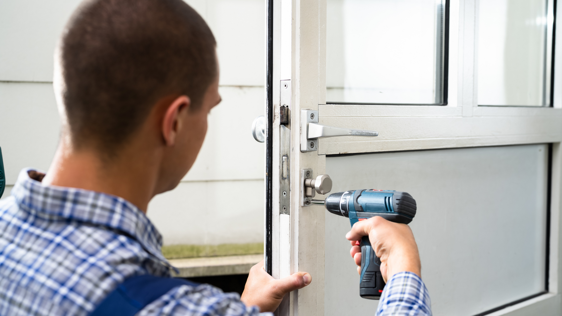 person changing the locks on a door of a home representing a landlord locking a renter out of their home