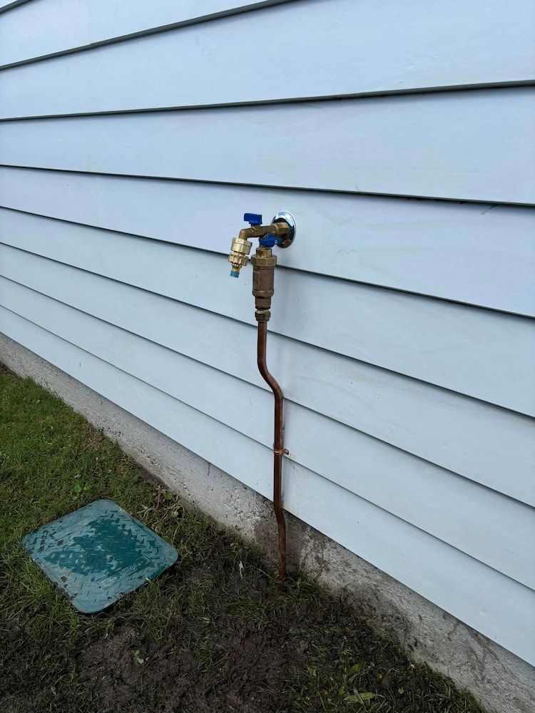 A Faucet is Attached to the Side of a House — Otto’s Plumbing & Gasfitting in McDowall, QLD