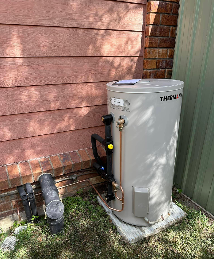 A Cylindrical Water Heater, Next to a Wall — Otto’s Plumbing & Gasfitting in Stafford, QLD