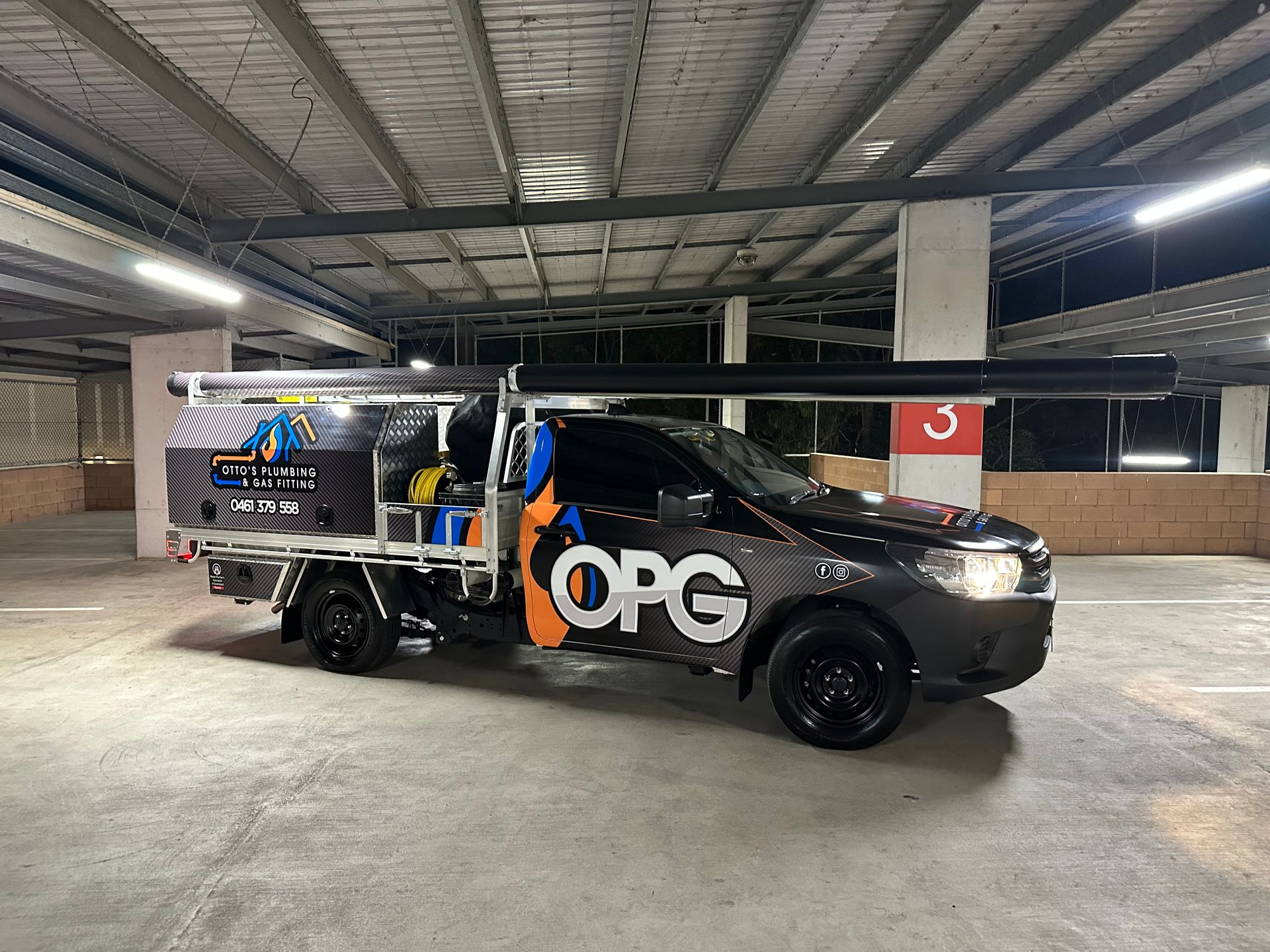 A Black Ute Has Pipes Running Along Its Roof — Otto’s Plumbing & Gasfitting in McDowall, QLD