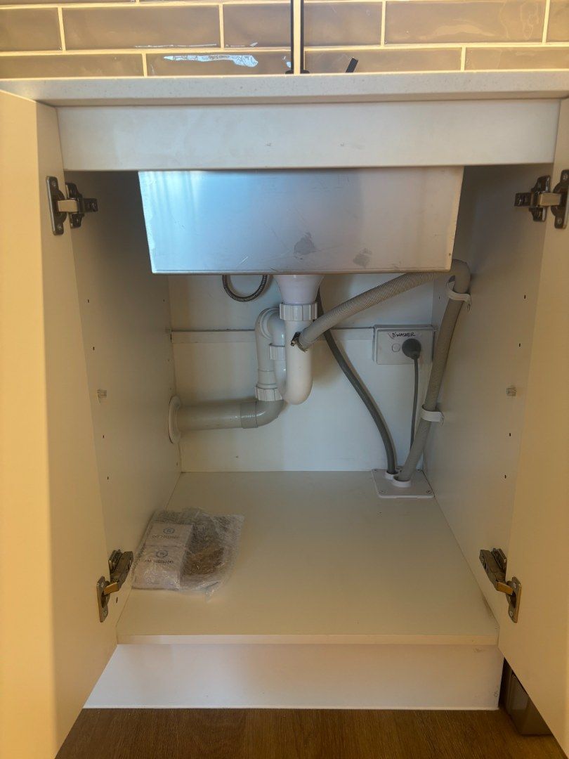 Open Kitchen Cabinet Under a Sink of a Restaurant — Otto’s Plumbing & Gasfitting in McDowall, QLD