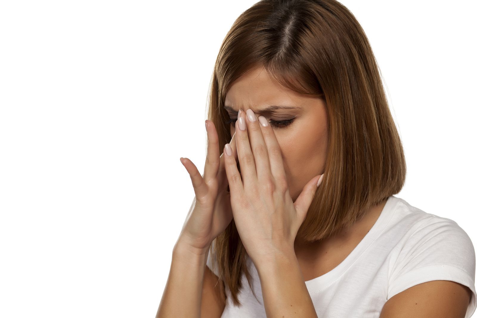 A woman suffering from facial pains due to sinusitis