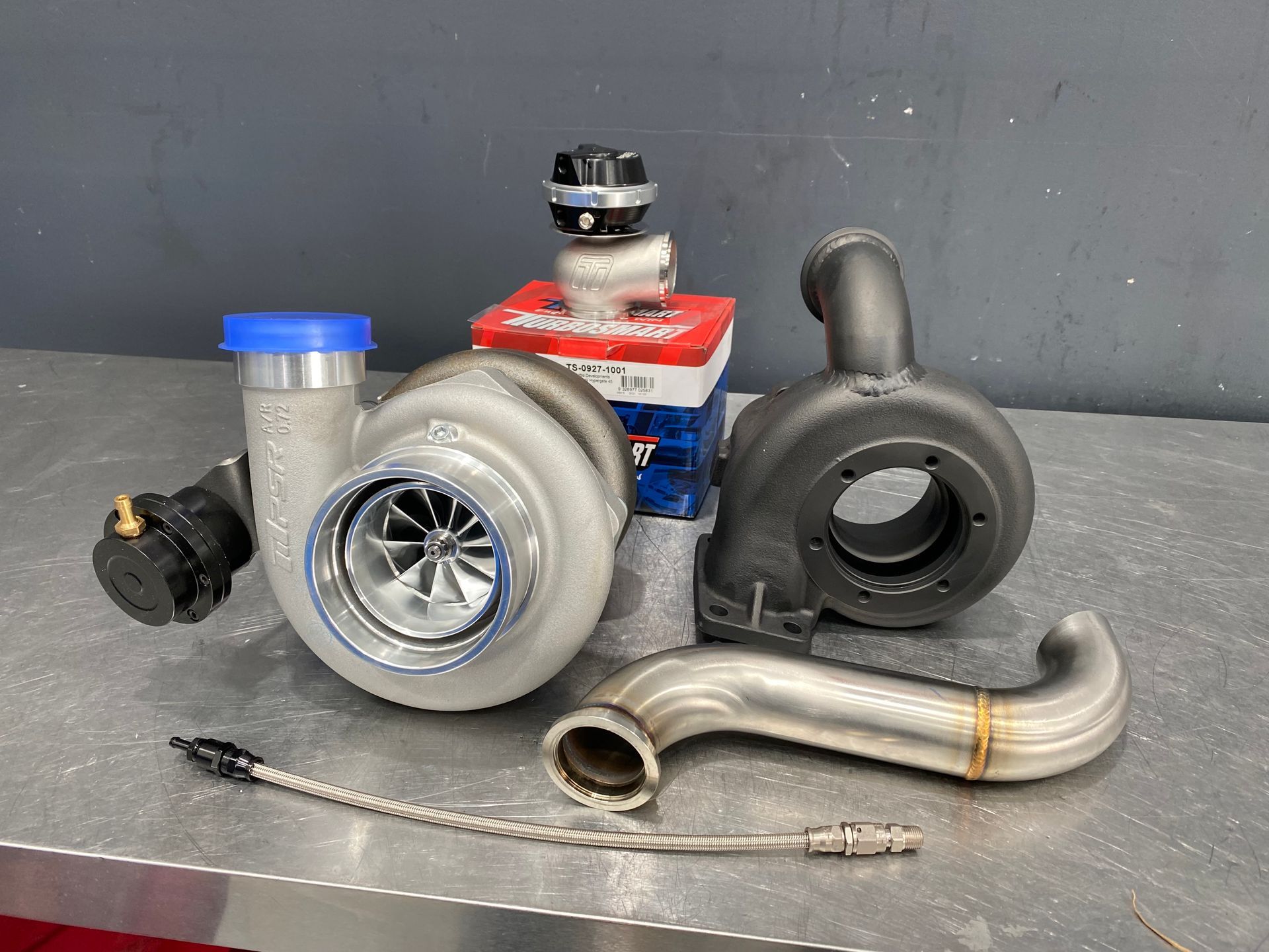A turbocharger is sitting on top of a stainless steel table. — HO Performance in Cleveland, QLD