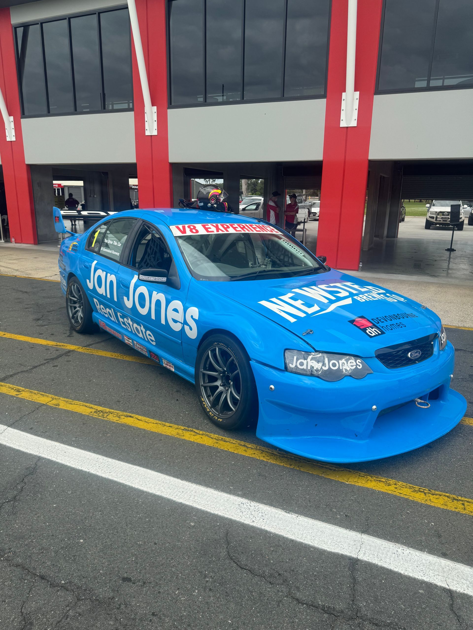 A blue race car is parked on the side of the road. — HO Performance in Cleveland, QLD