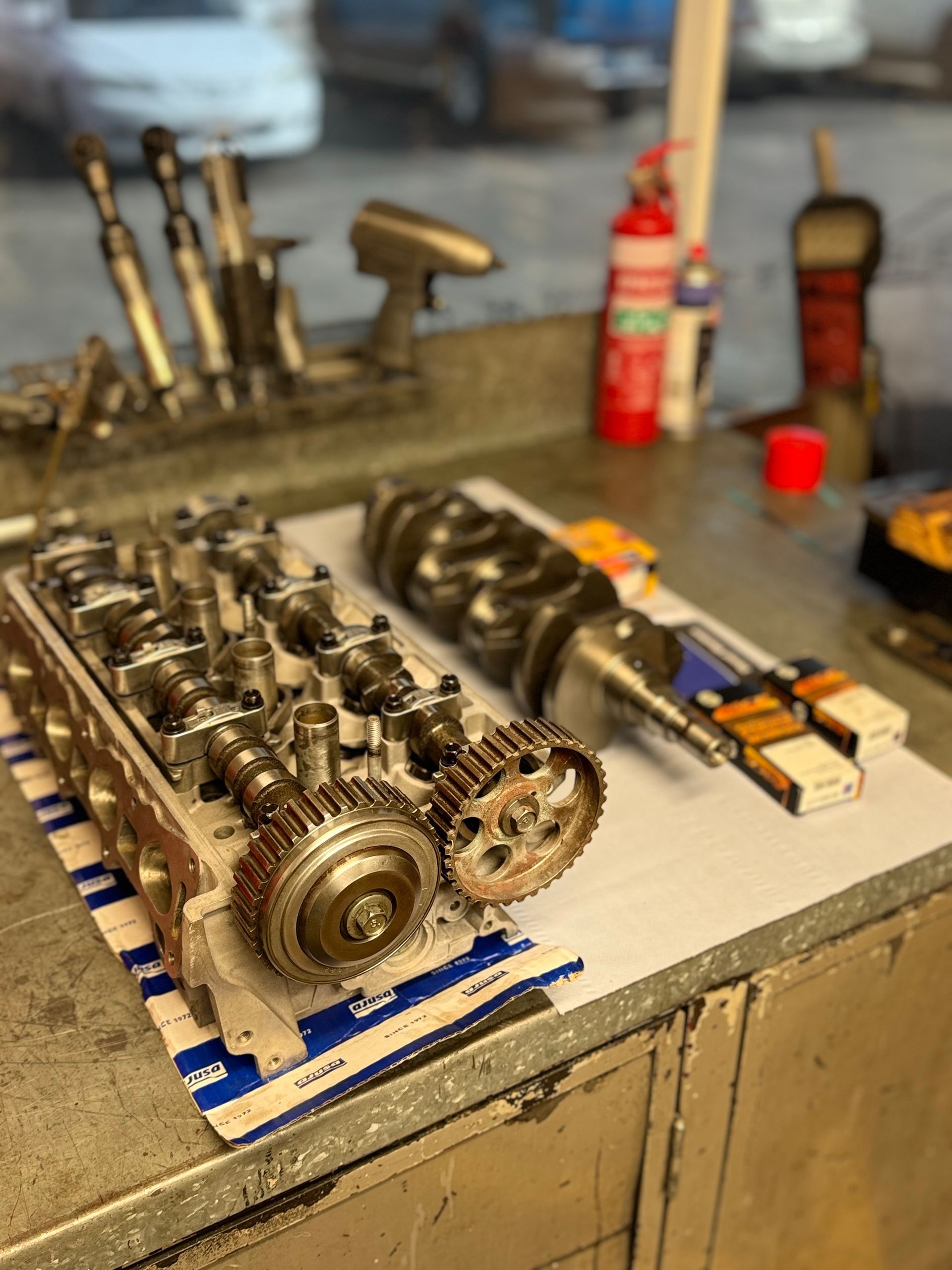 A car engine head is sitting on a counter in a garage. — HO Performance in Cleveland, QLD
