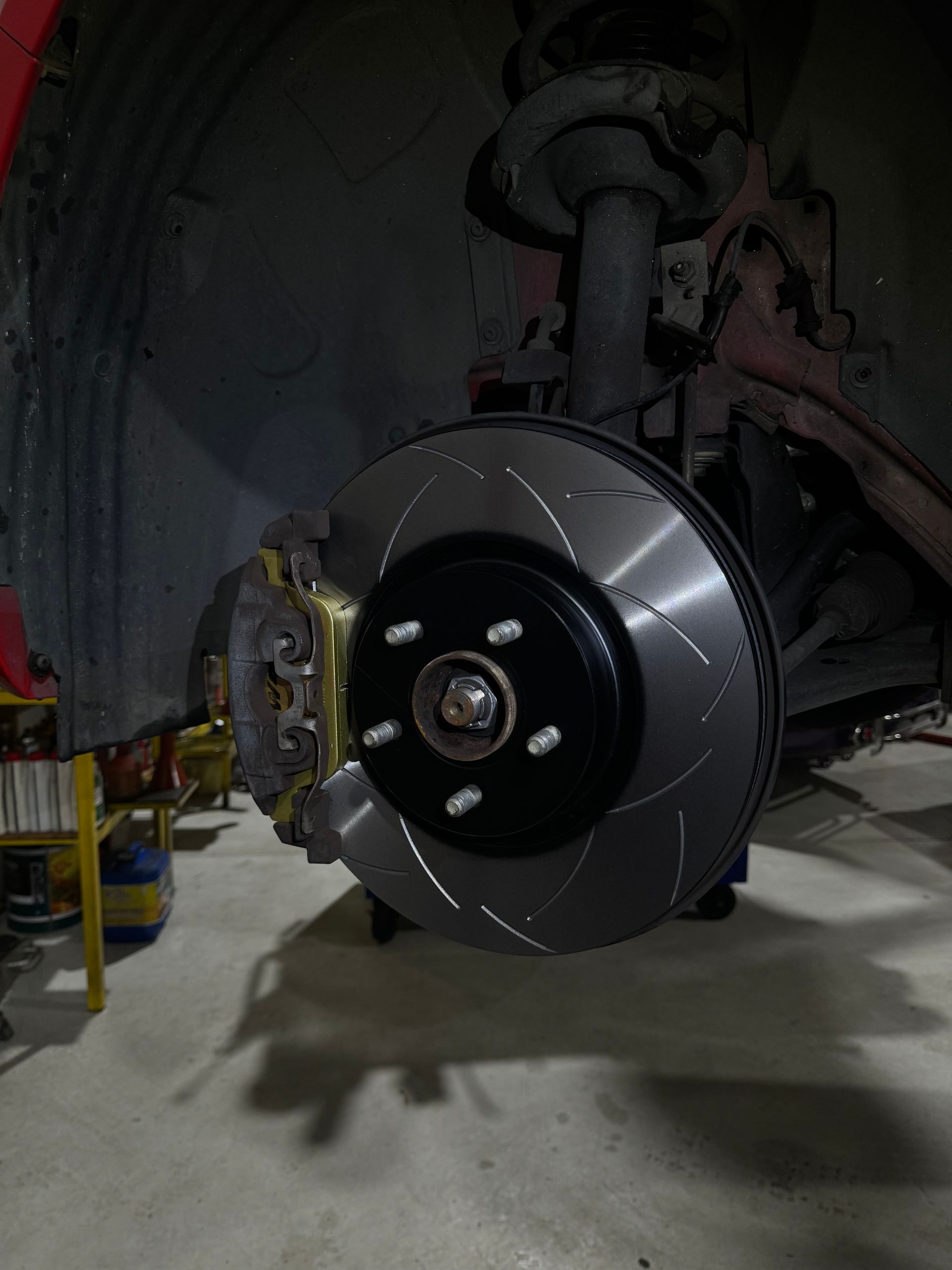 A Person Is Fixing a Brake Disc — HO Performance in Cleveland, QLD