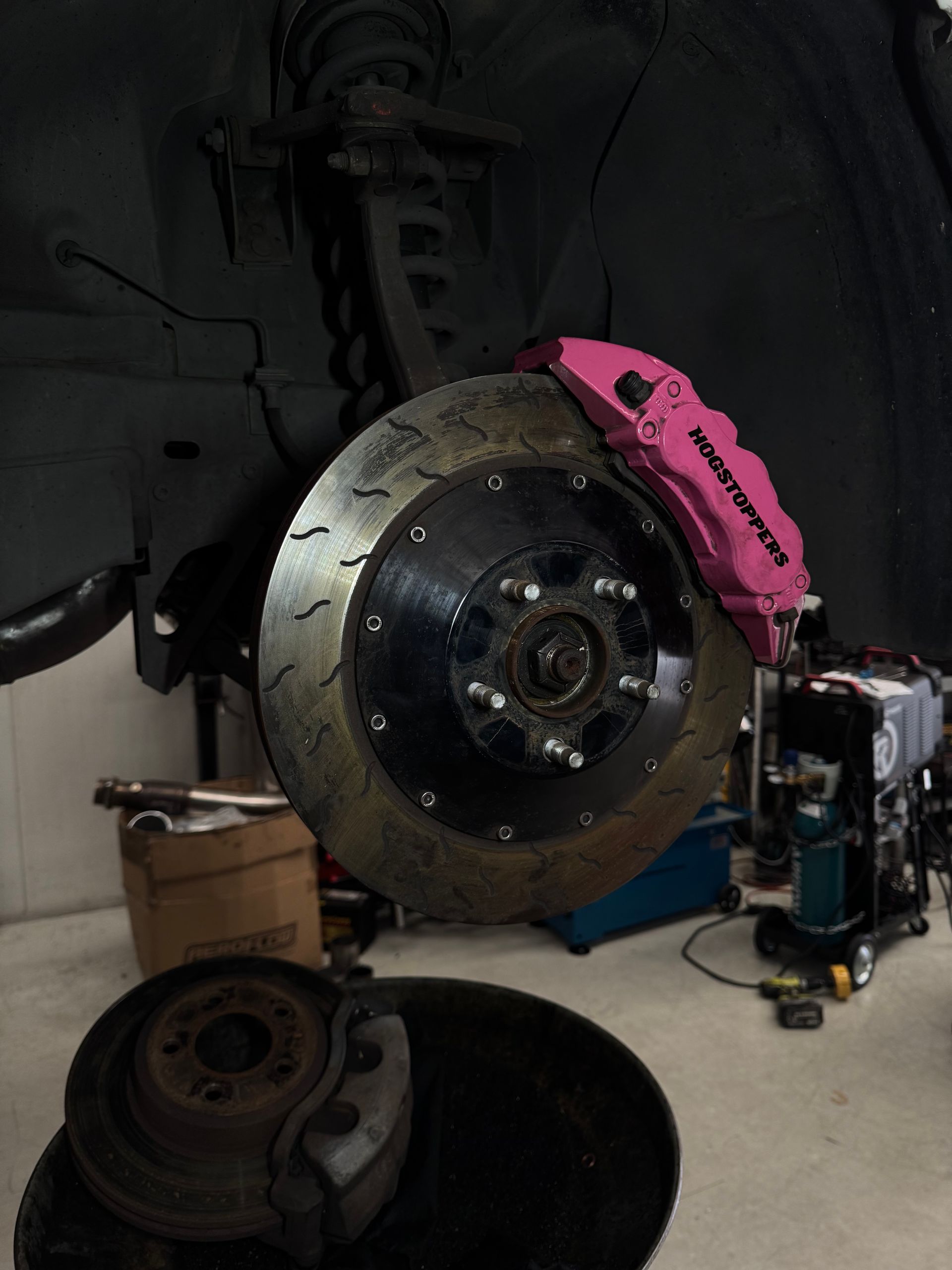 A Person Is Fixing a Brake Pad — HO Performance in Cleveland, QLD