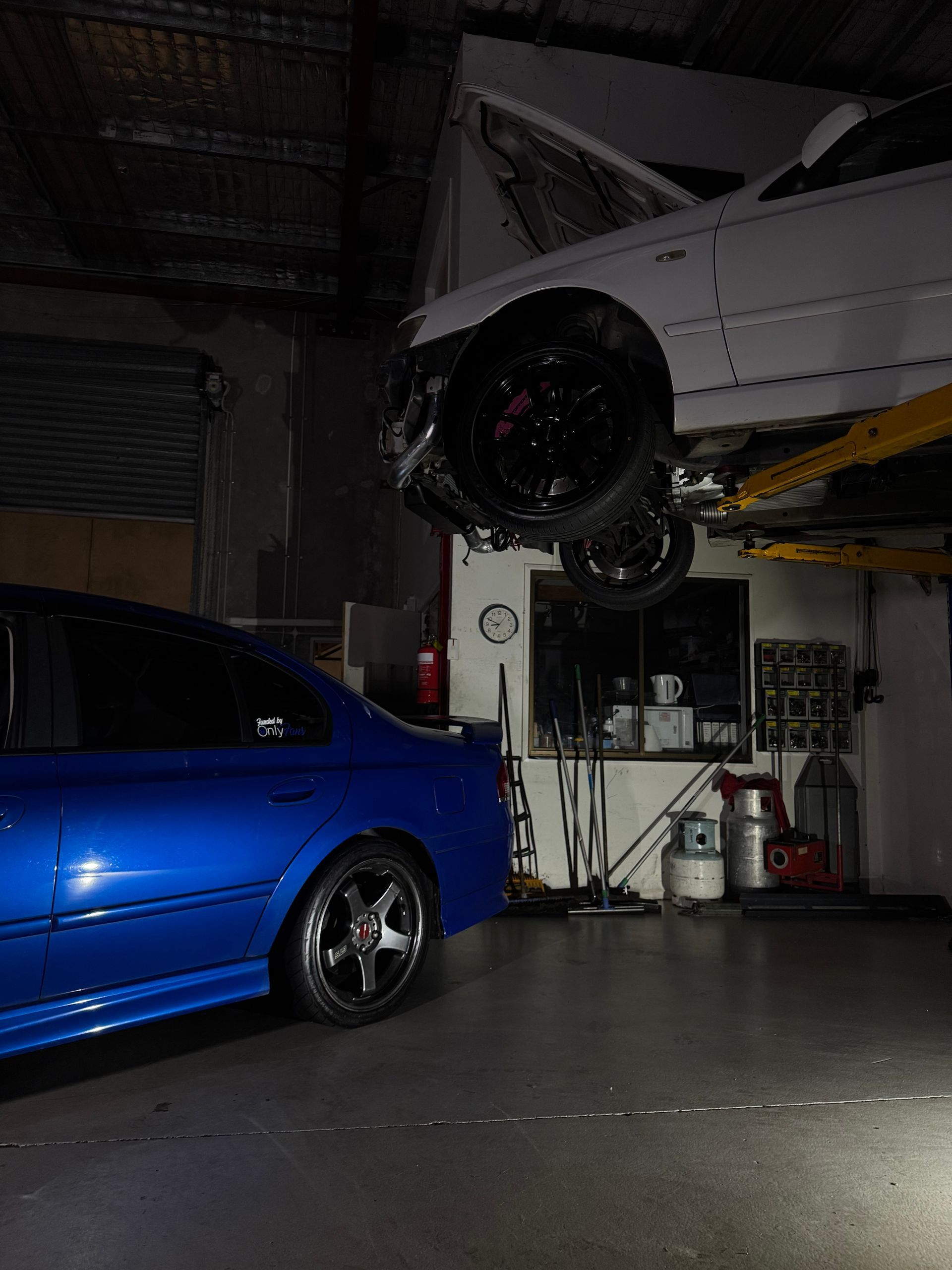 A Man Is Adjusting the Alignment of A Car — HO Performance in Cleveland, QLD