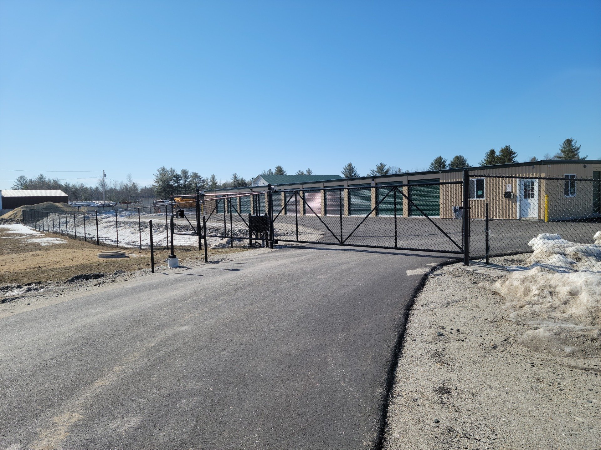a fence with a gate in front of a building