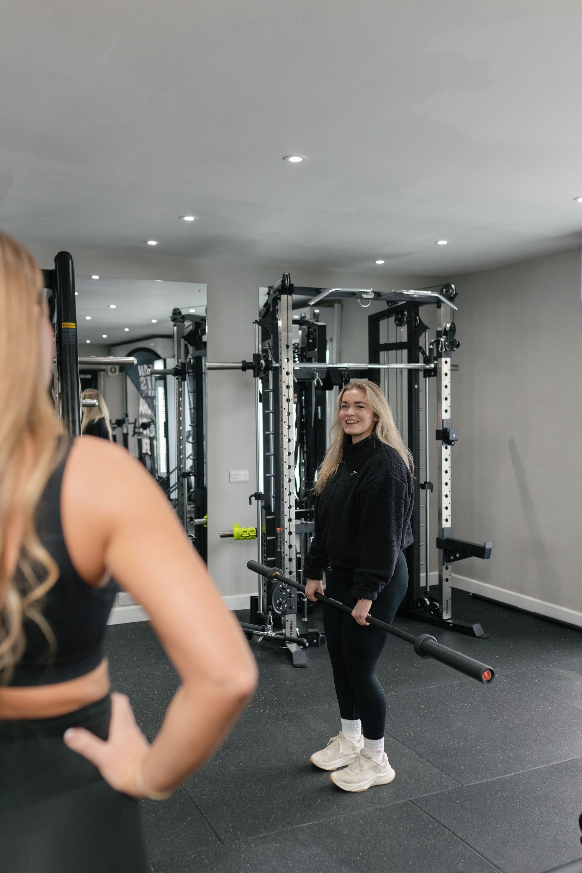 A man in a gym wearing a tank top that says lifting