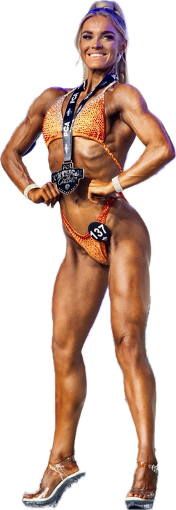 A shirtless man in shorts is standing with his hands on his hips.