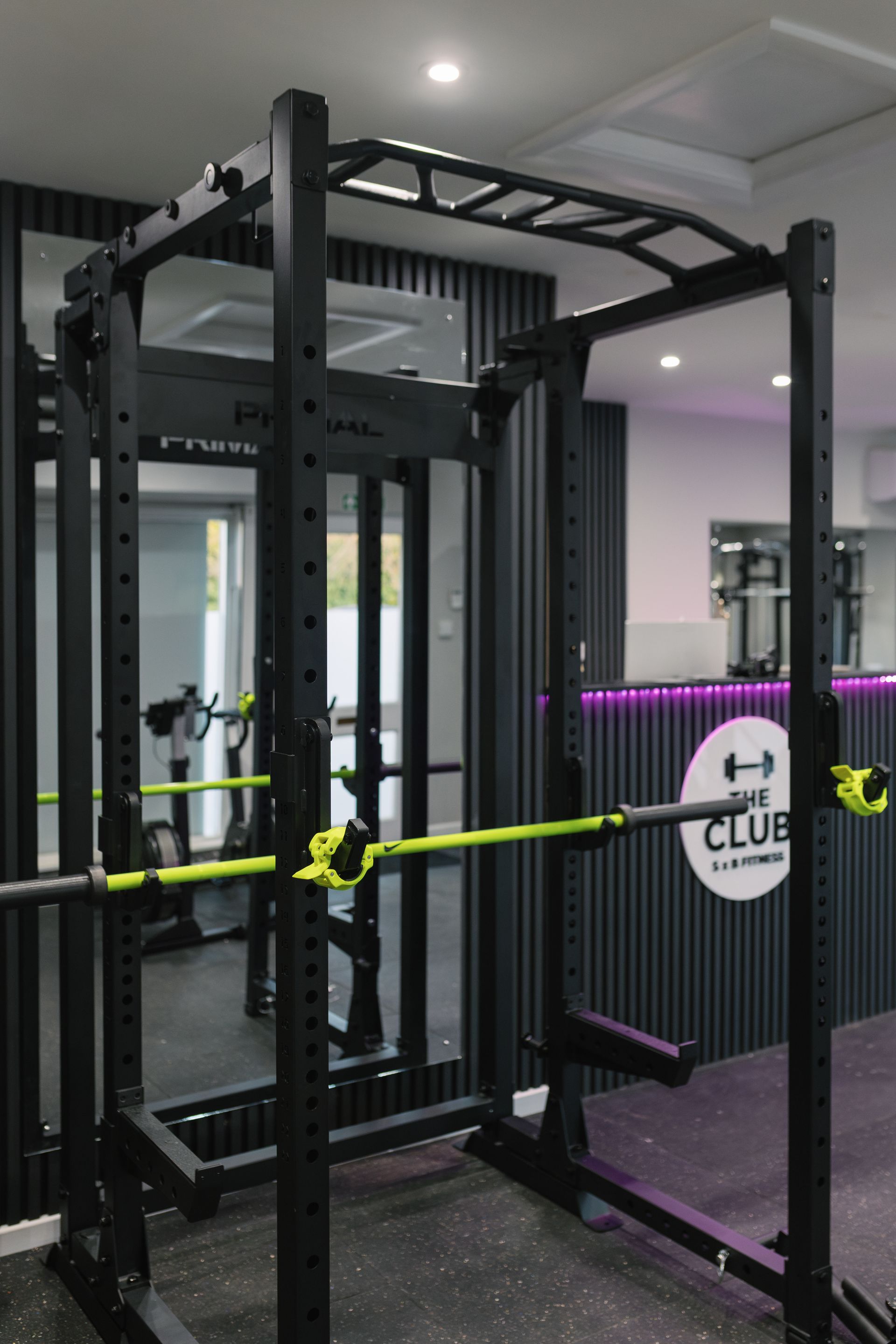 A gym with a lot of weights on the racks