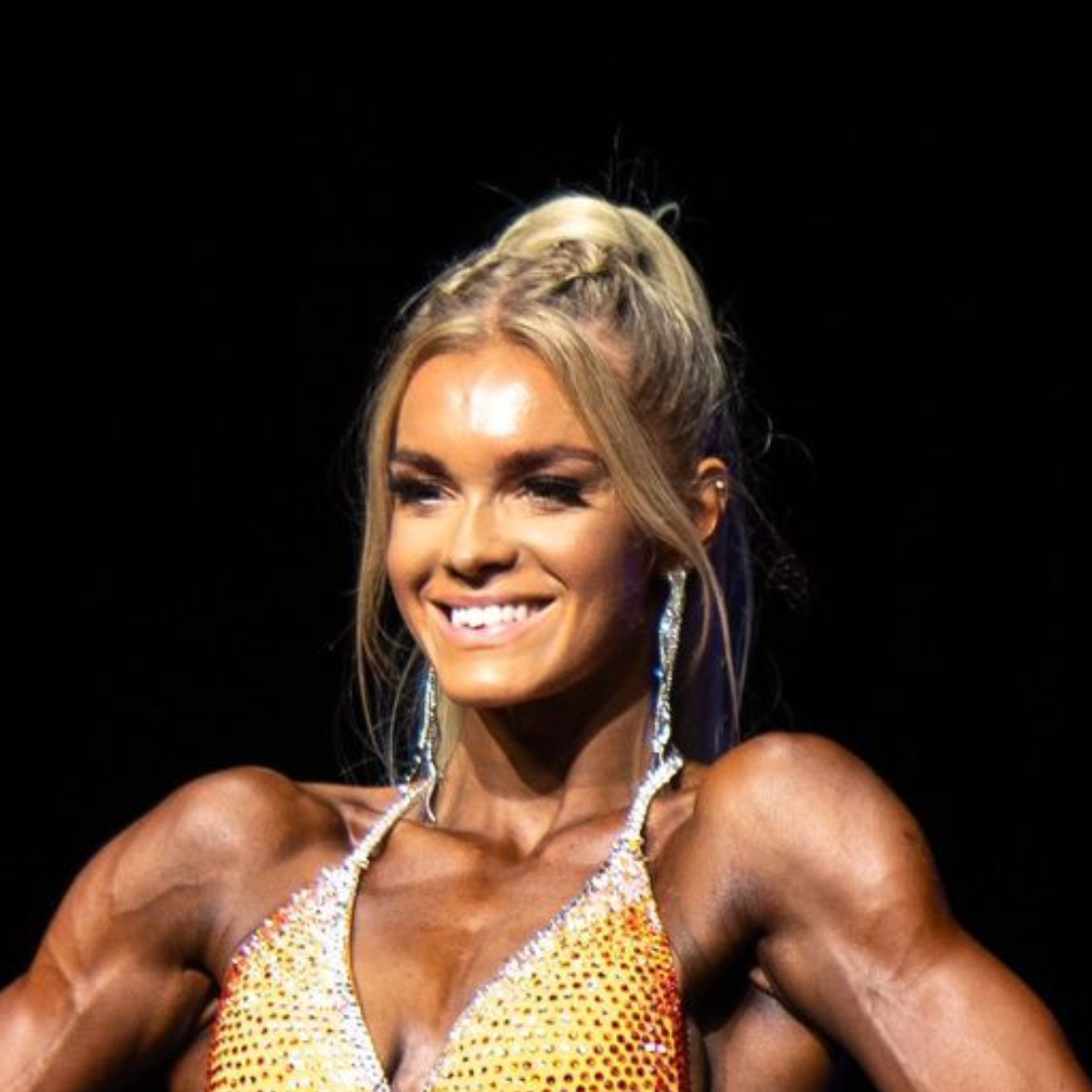 A man with a beard and blue eyes is wearing a black shirt