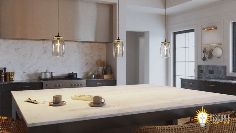 Kitchen with hanging lights, stainless steel appliances, and a large island with two cups and saucers.