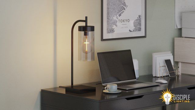 Desk with lamp, laptop, and coffee cup; Tokyo map art on wall.