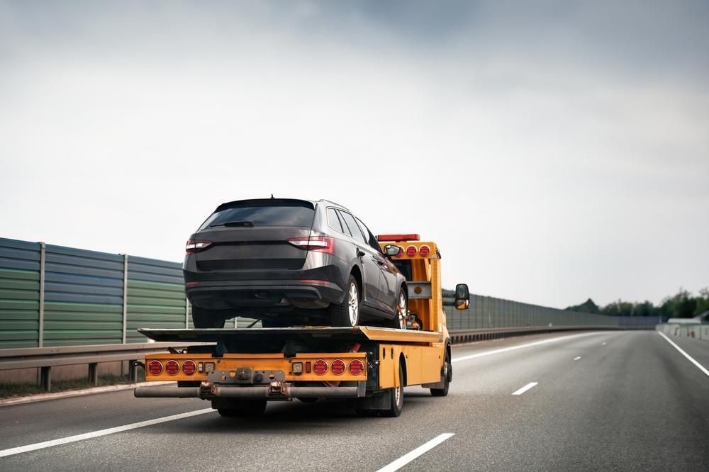 A Tow Truck is Towing a Car on the Highway — Bulahdelah Towing In Coolongolook, NSW