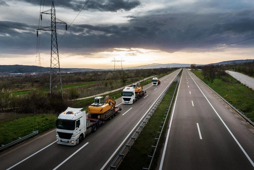 A Group of Trucks Are Driving Down a Highway — Bulahdelah Towing In Karuah, NSW