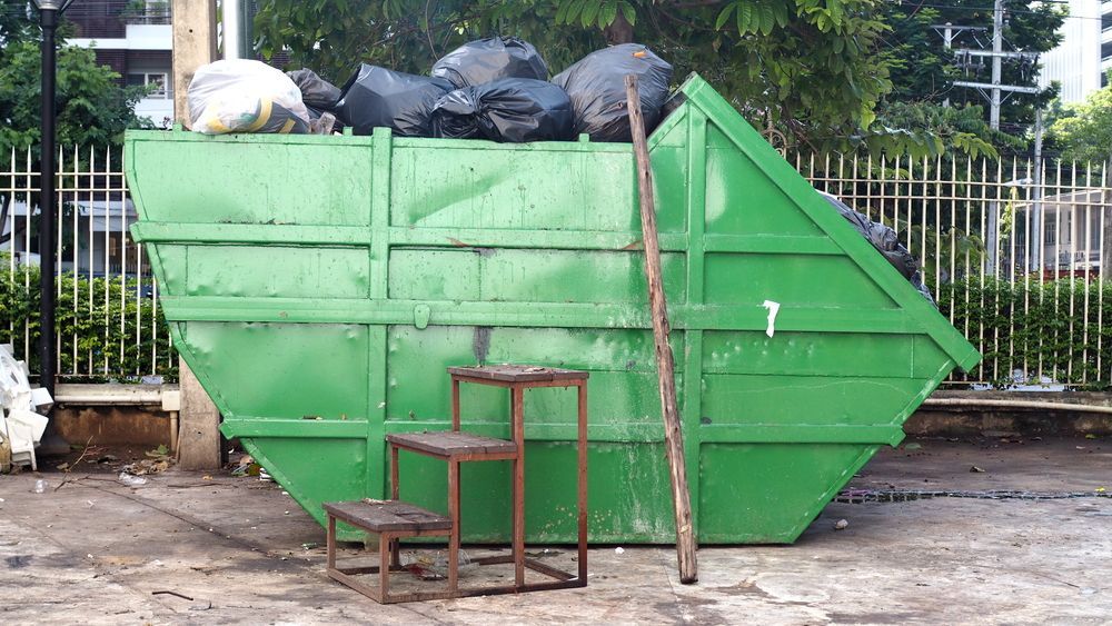Green Dumpster Overflowing — Tamworth Skips and Rubbish Removal in South Tamworth, NSW