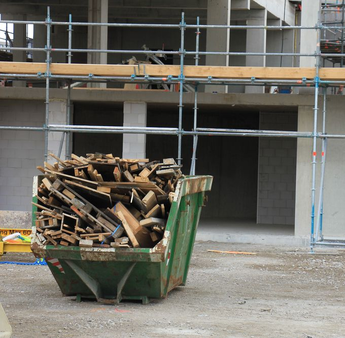 Green Dumpster Filled With Wooden Debris — Tamworth Skips and Rubbish Removal in South Tamworth, NSW