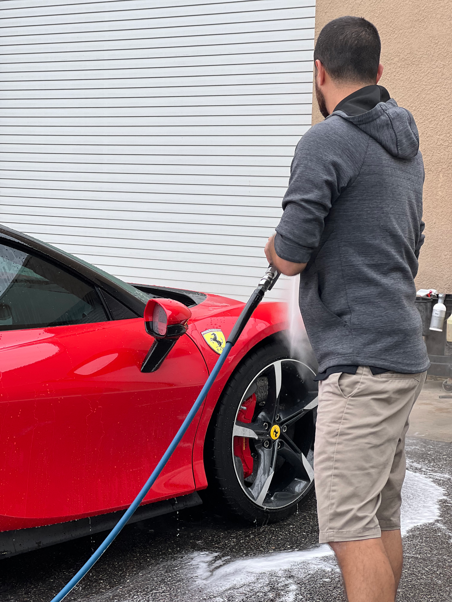 A person is cleaning the interior of a car with a vacuum cleaner.