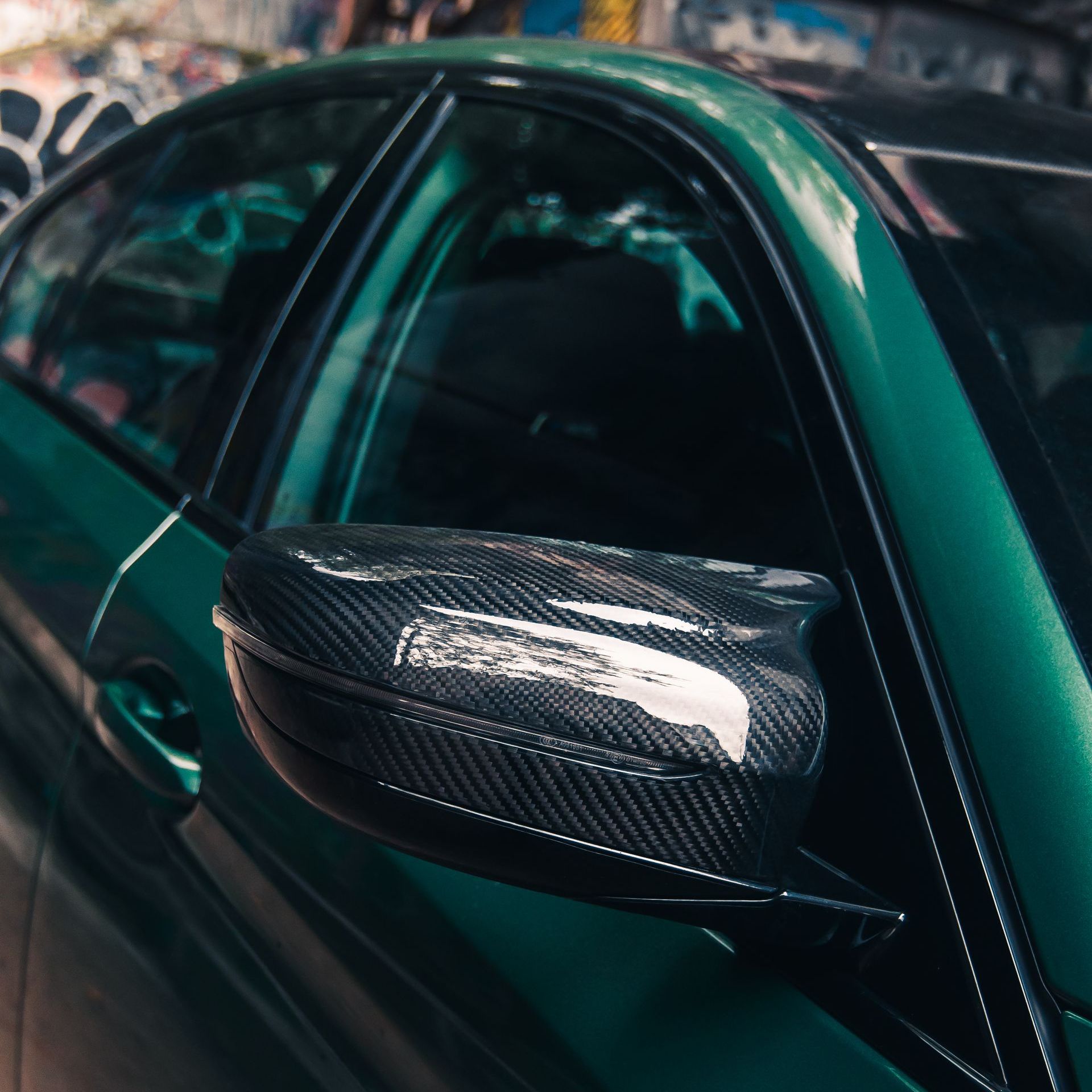 A man is applying window tinting to a car door