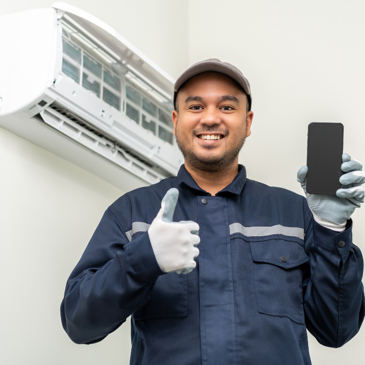 A man is holding a cell phone and giving a thumbs up