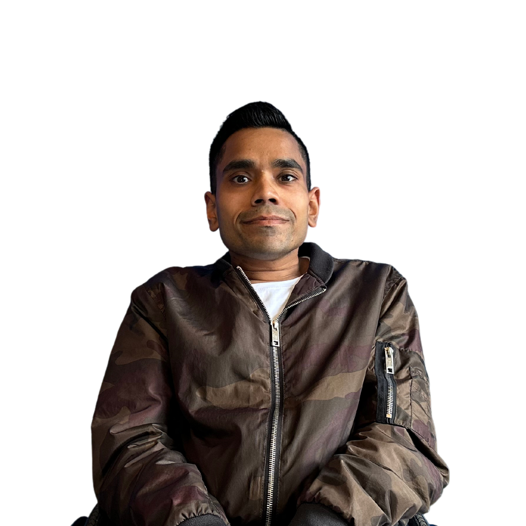 A man in a camouflage jacket is sitting in a chair.