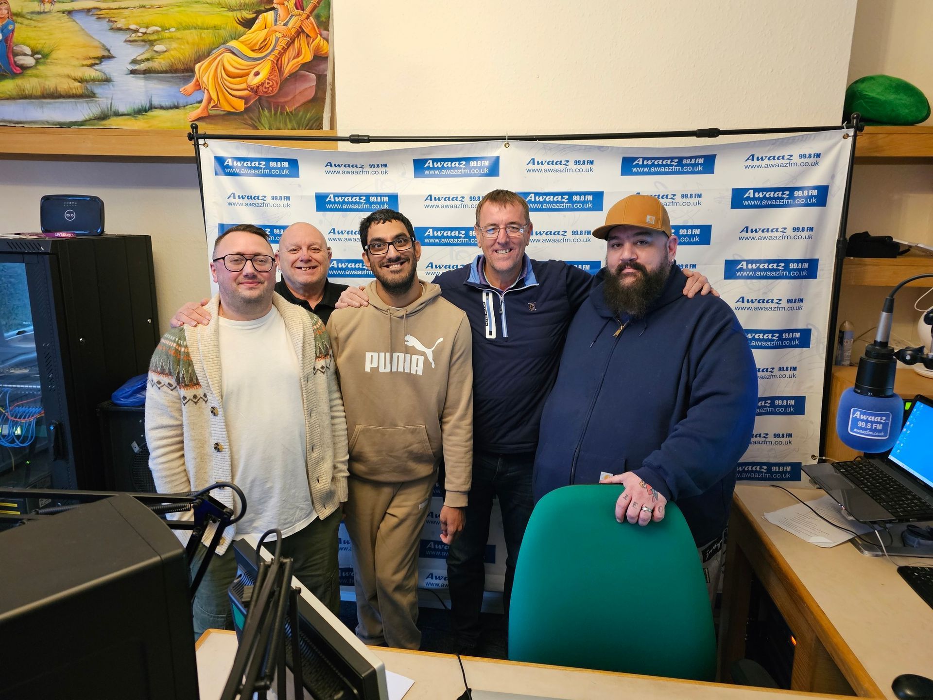A group of men are posing for a picture in a room.