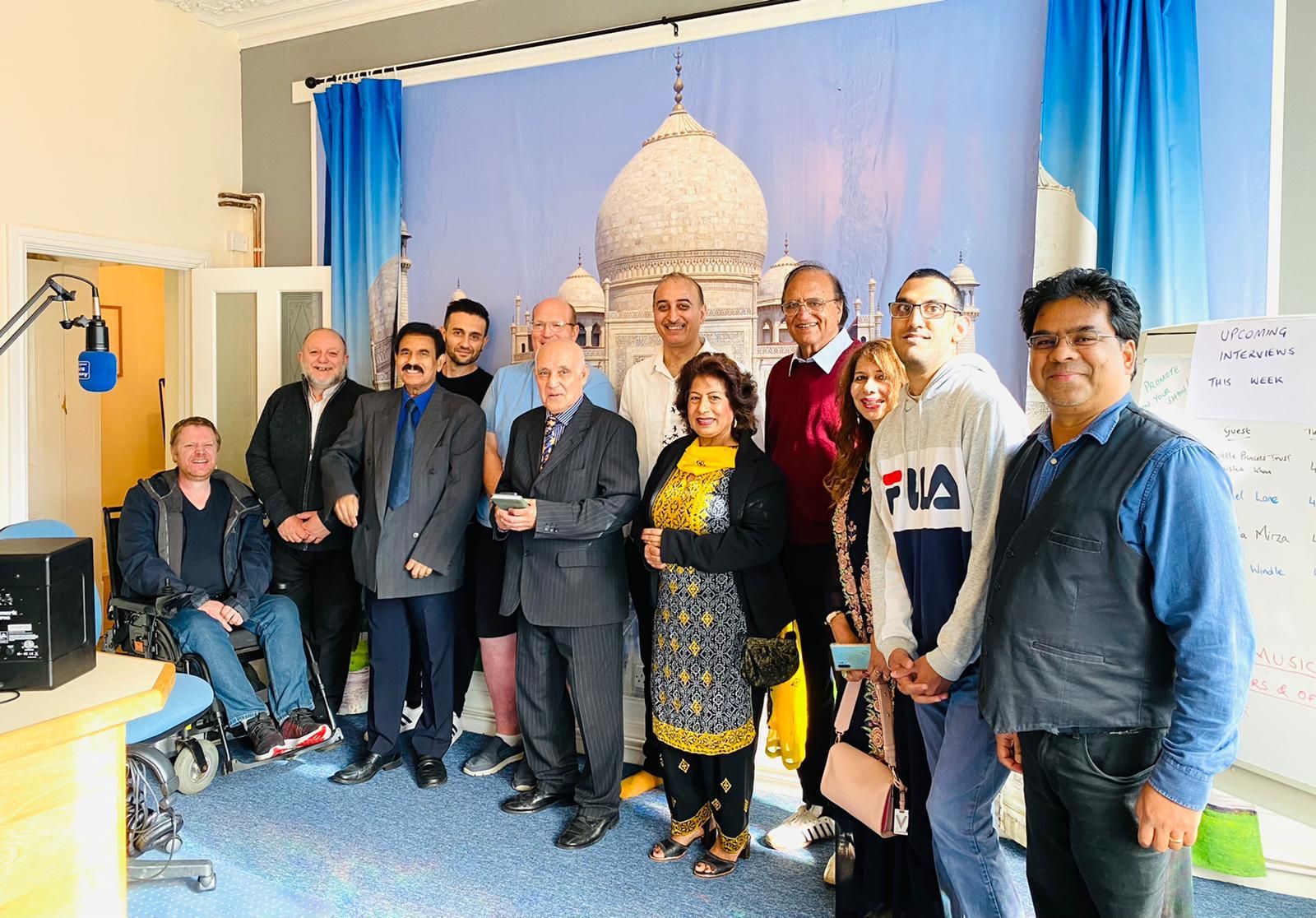 A group of people are posing for a picture in a room.